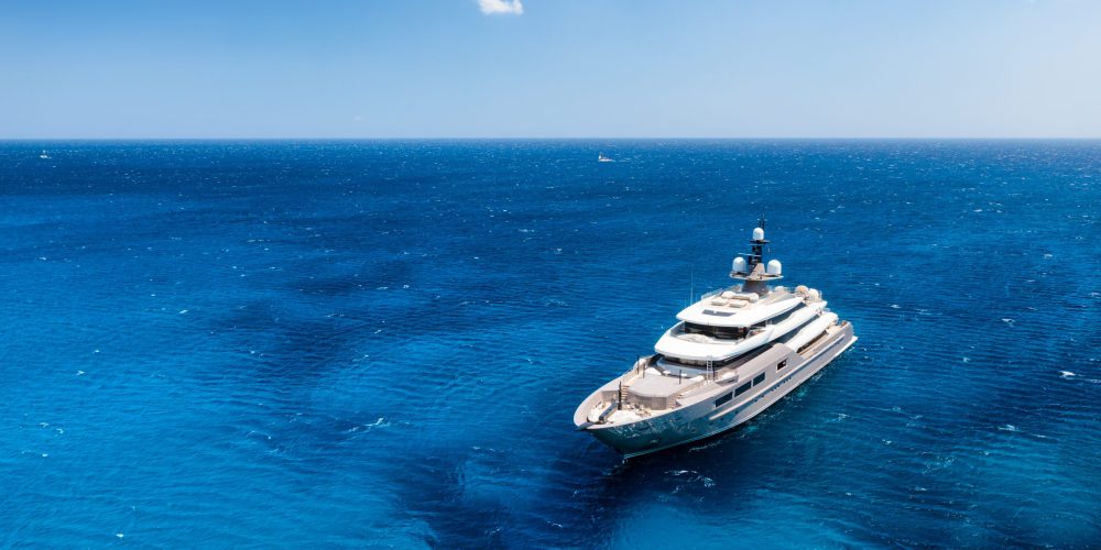 Aerial view of the ship from drone. Blue clear water in the Mediterranean Sea. Summer vacation and travel on a cruise liner. Summer trip.